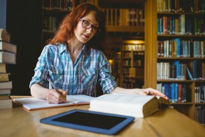 Mature student studying in library