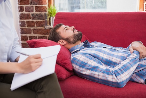 Depressed patient lying on couch