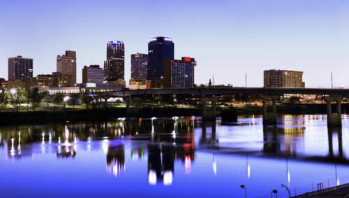 Little Rock Arkansas skyline at dusk with city lights reflecting in Arkansas River, representing career opportunities for licensed marriage and family therapists